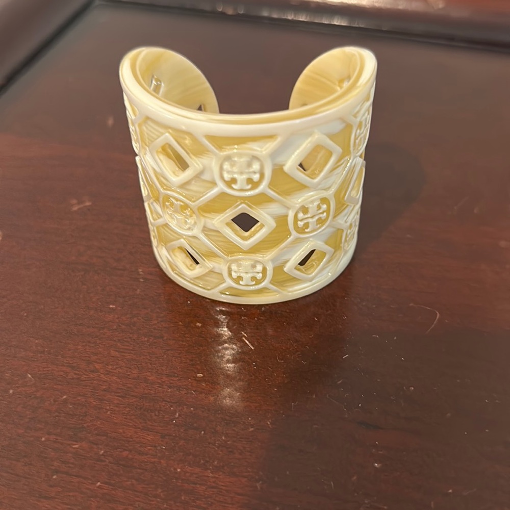 Tory Burch logo cuff. Plastic enamel. Bailey and crème